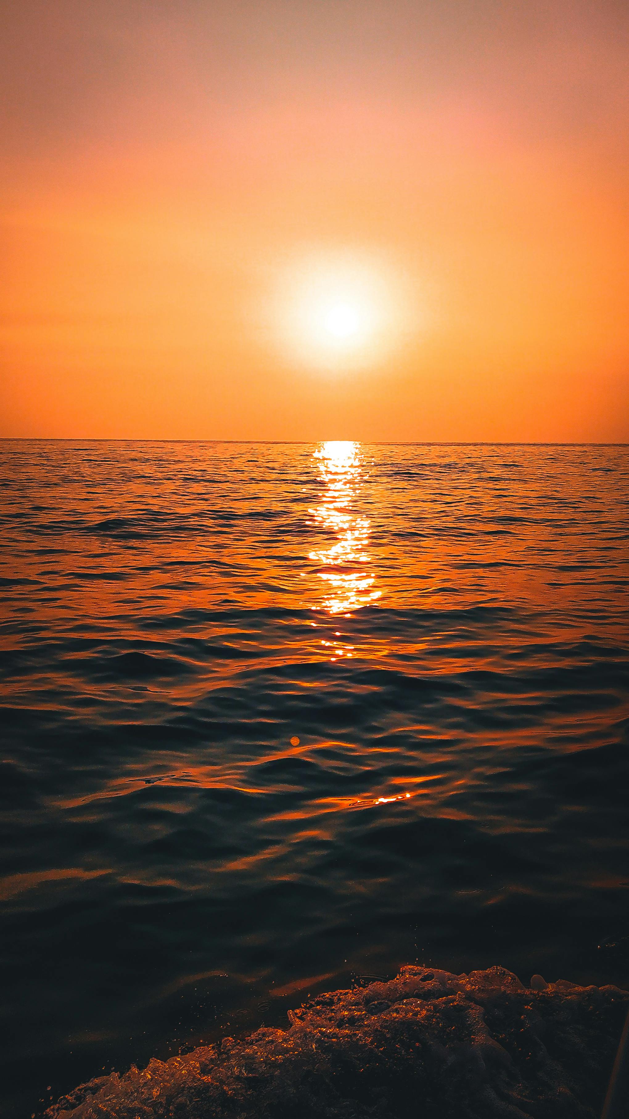 Calm Water With Sun And Orange Sky · Free Stock Photo