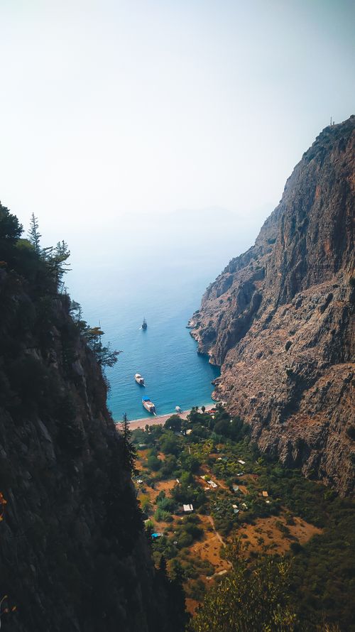 Free A breathtaking aerial view of a cliff-lined bay on the Mediterranean coastline with clear blue water. Stock Photo