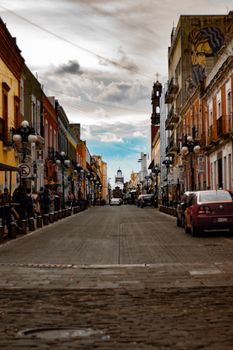 Colorful colonial architecture and lively streetscape in Puebla, Mexico.