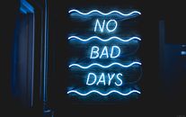 Bright neon sign reading 'No Bad Days' against a dark background.
