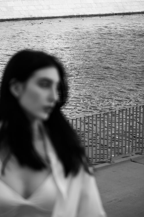 Black and White Photo of a Woman near the Water