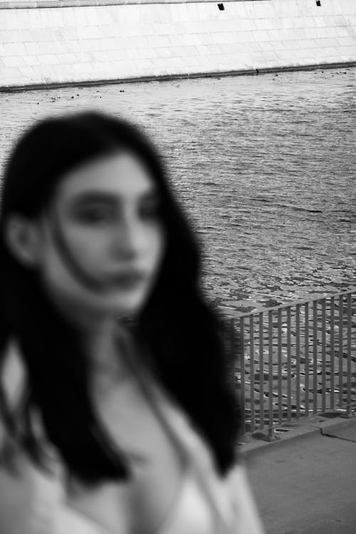 Grayscale Photo of a Woman near the River