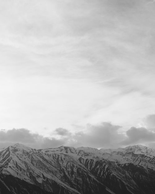 Free Breathtaking aerial view of a mountain range in black and white, capturing the majestic peaks. Stock Photo