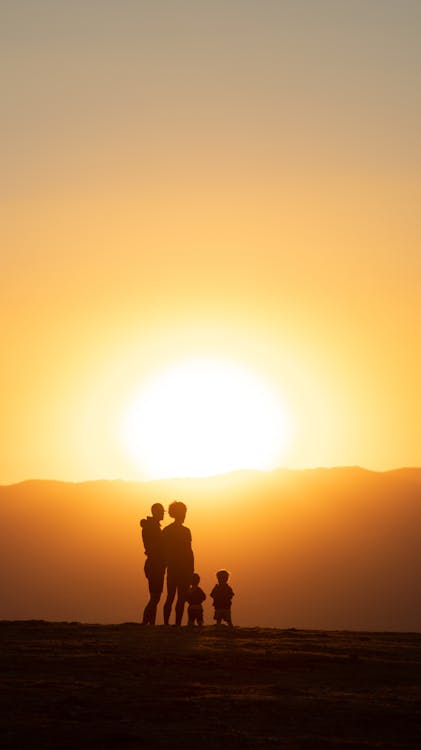 Silhouette of a Family Standing Together