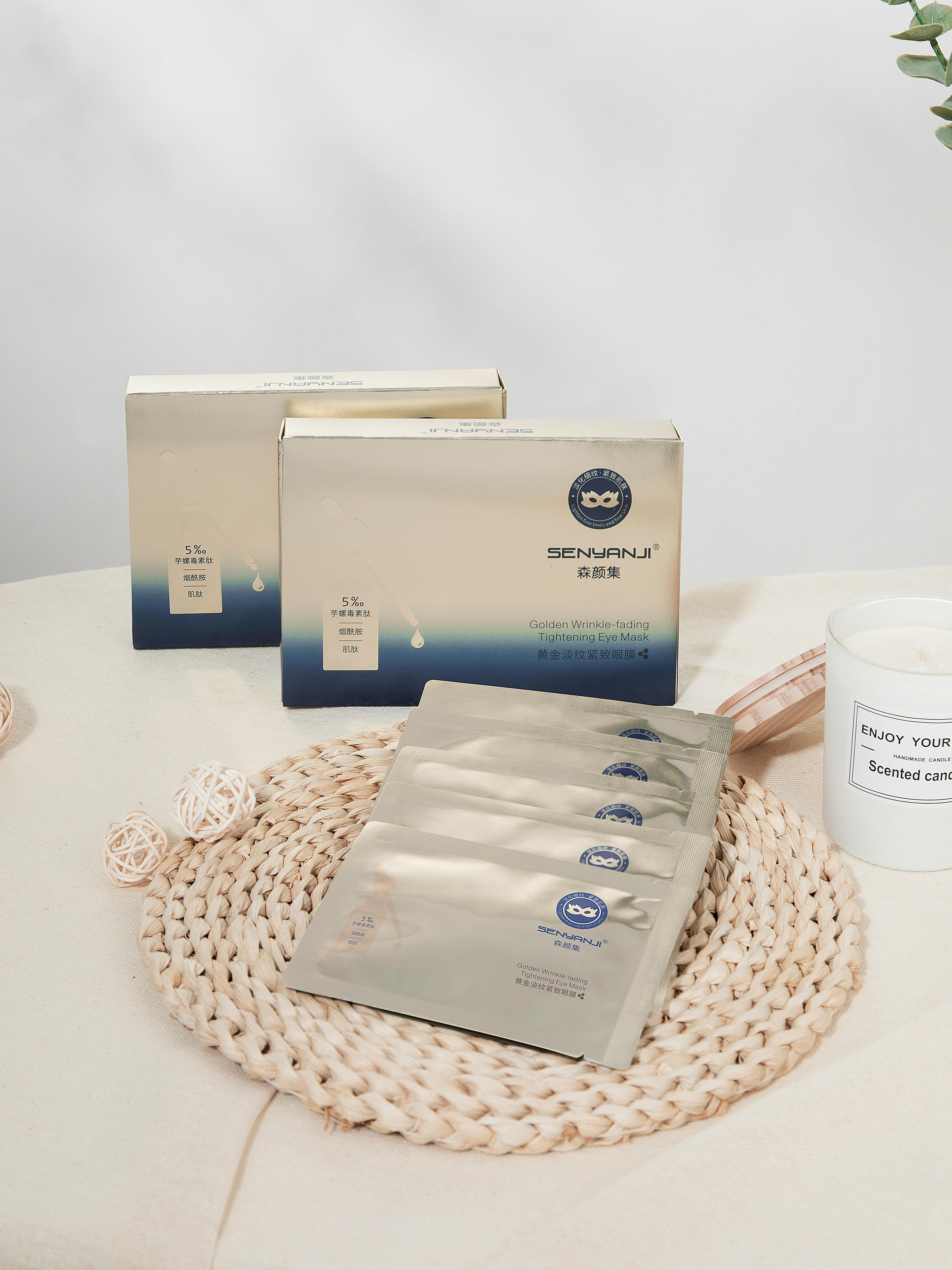 Elegant arrangement of SENHANJI Collagen face masks on a woven mat, ideal for skincare and beauty themes.