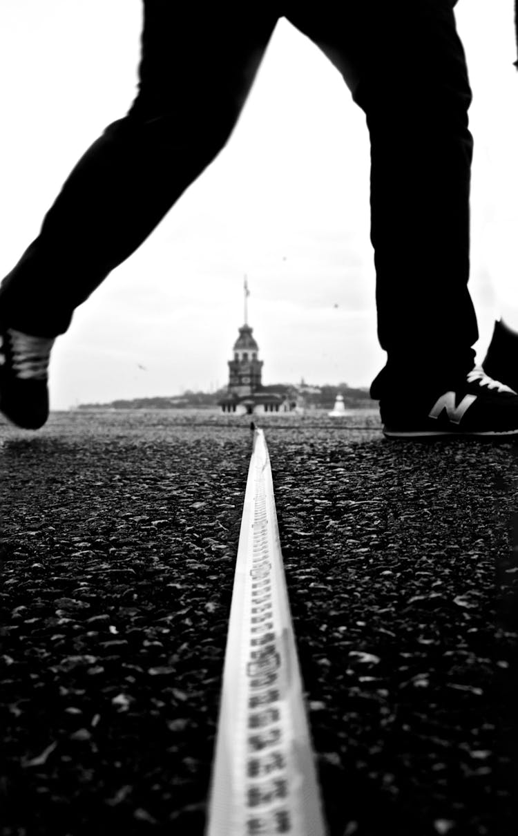 Close-up Of Man Crossing Border On Ground