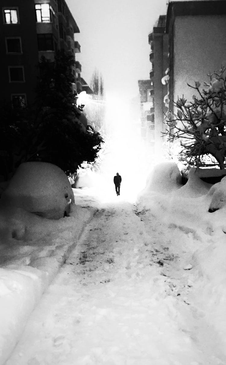 Man Walking Winter Street In Snow