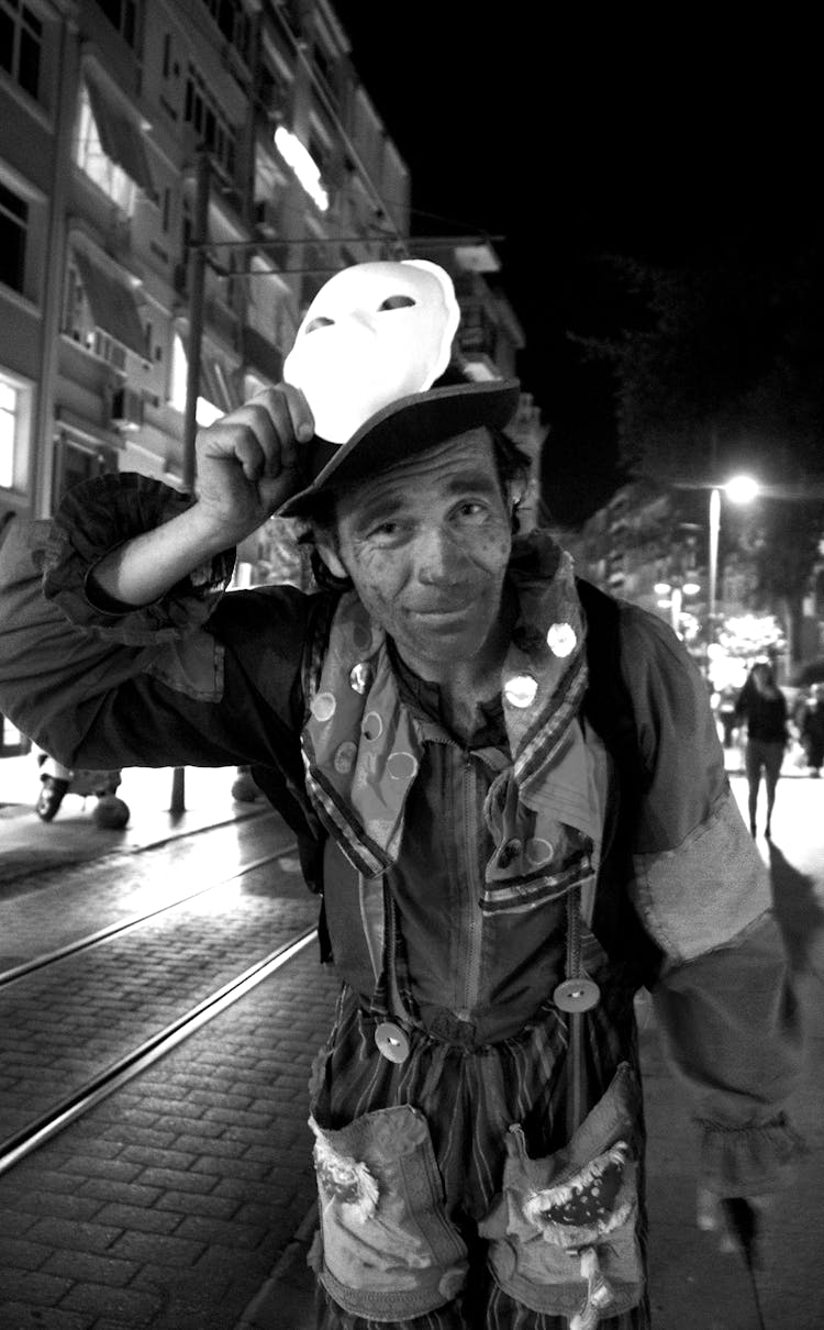 Old Man In Costume On Night City Street
