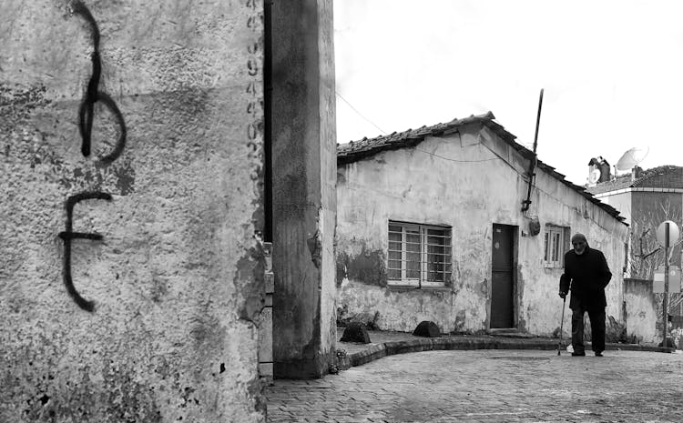 Elderly Man Walking On Town Street