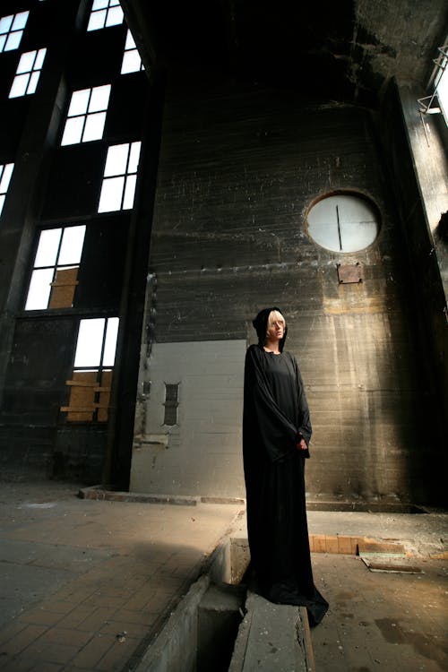 Standing Woman Wearing Black Long-sleeved Dress