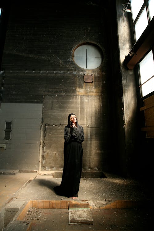 Standing Woman Wearing Black Dress in Building