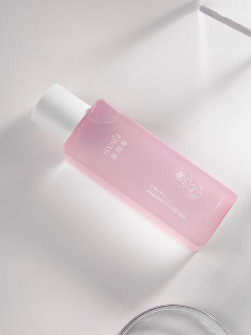 Free A pink skincare bottle with embossed details in a luxurious and minimalist setting. Stock Photo
