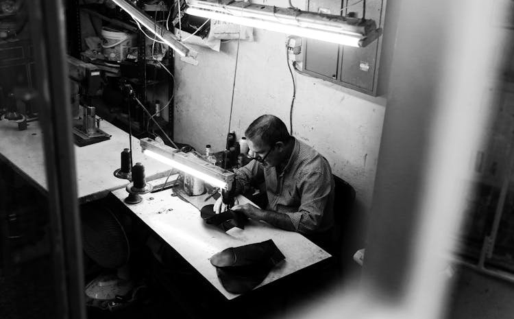 Man Sewing In His Workshop 