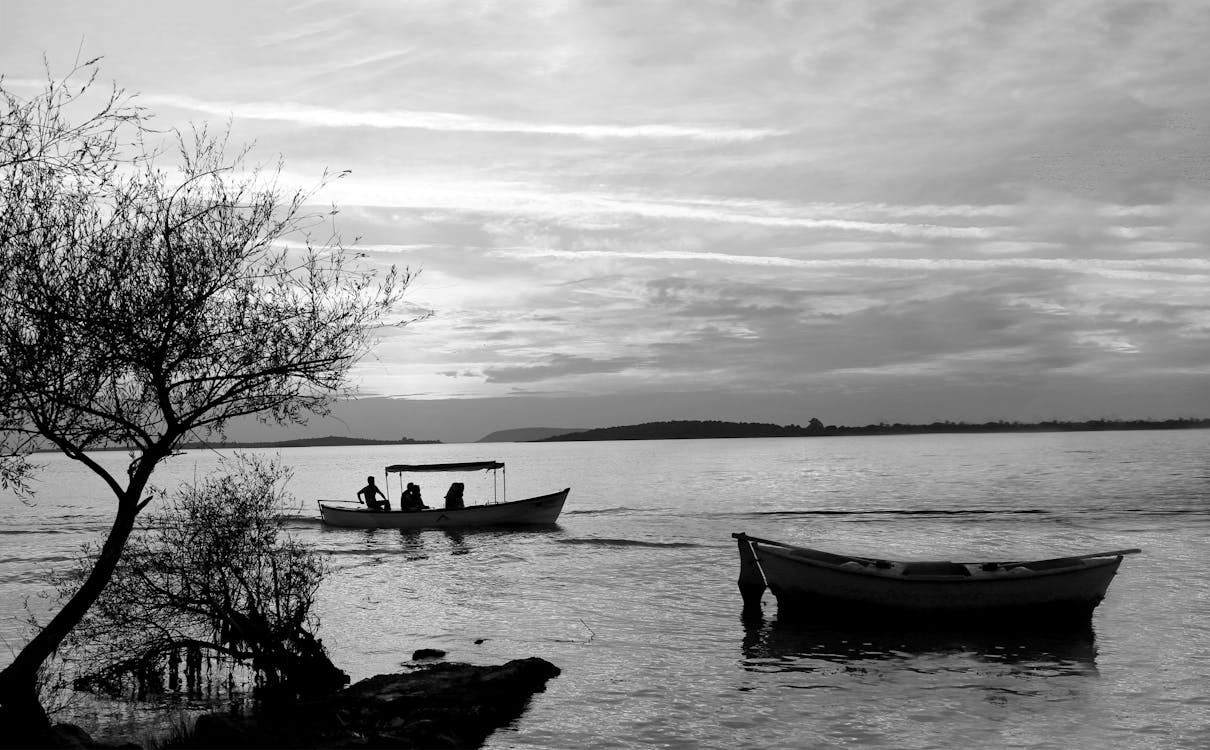 Grayscale Photo of Boats on Sea