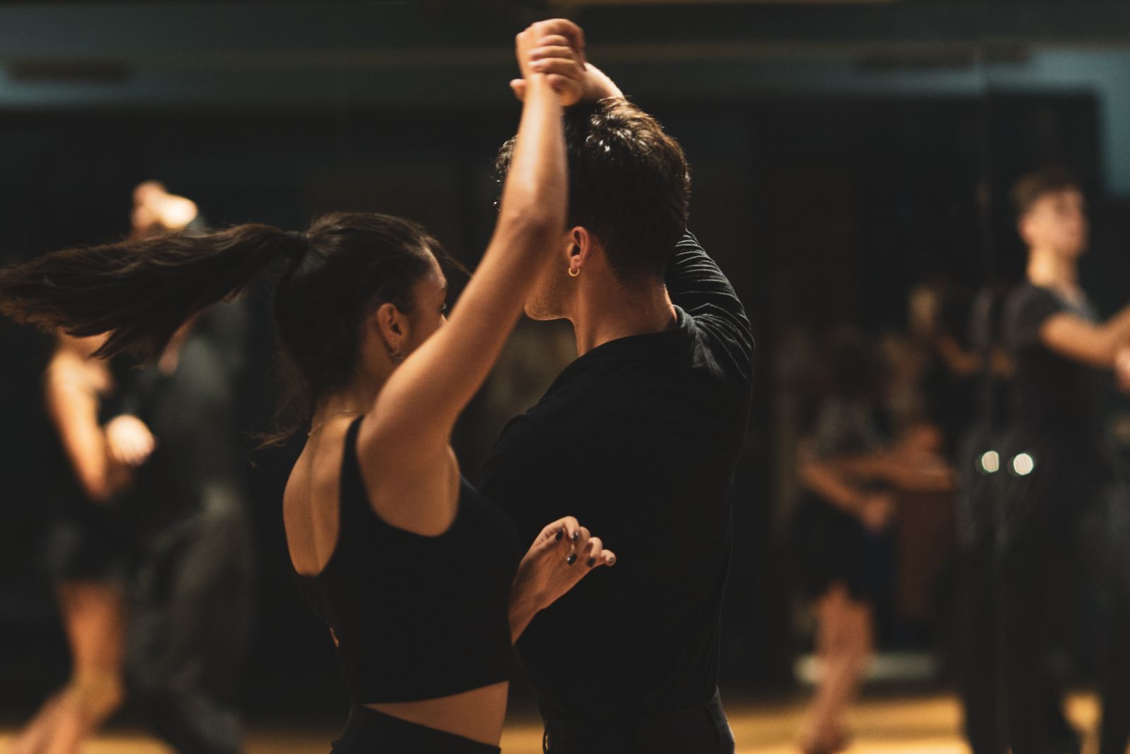 Couple practicing precise salsa footwork technique in a dedicated dance studio session