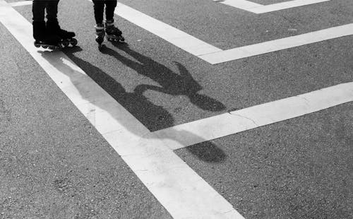 Two People Wearing Roller Skates