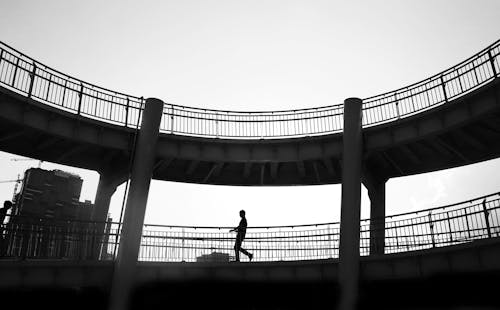 Man Walking on Footbridge