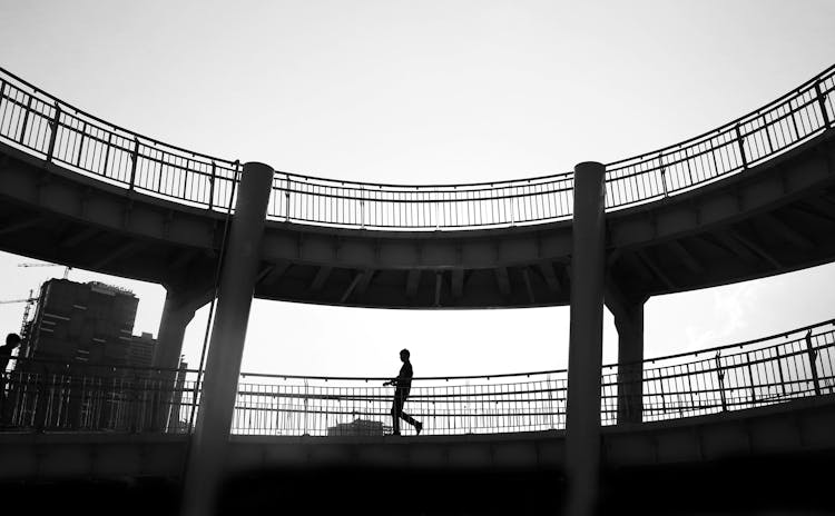 Man Walking On Footbridge