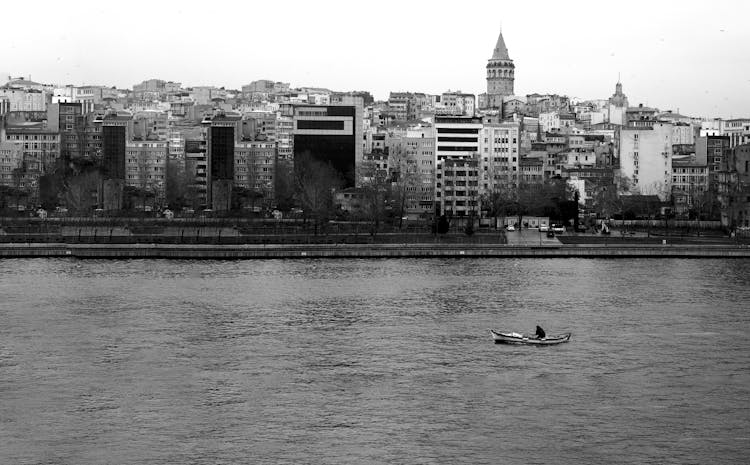 Grayscale Photo Of A Boat On The River