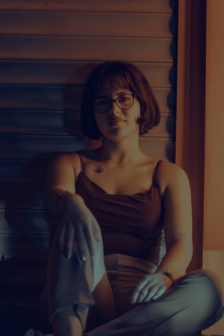 Photo Of A Woman In Glasses Sitting On The Floor