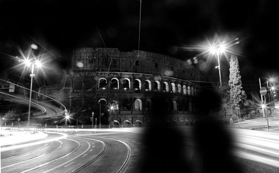 A stunning black and white long exposure shot of the Colosseum in Rome at night.