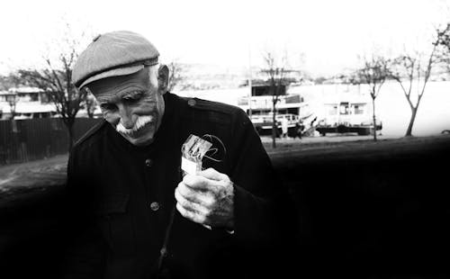 A Man in Black Jacket Wearing a Cap