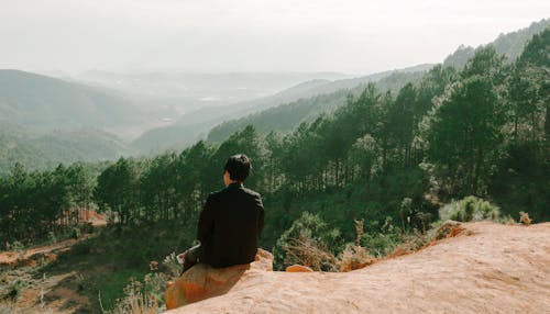 Free Person Sitting Near Hill Cliff Stock Photo