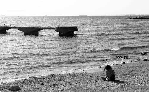 Foto d'estoc gratuïta de assegut, blanc i negre, d'esquena