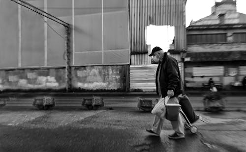 Man in Black Jacket Walking on the Street