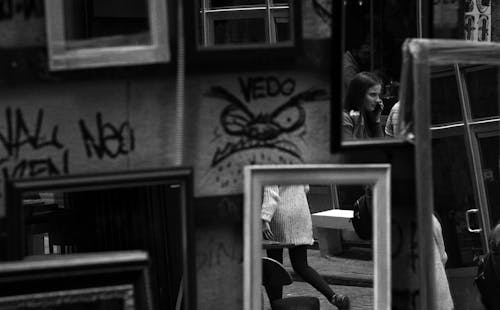 Black and White Photograph of Framed Mirrors on a Street