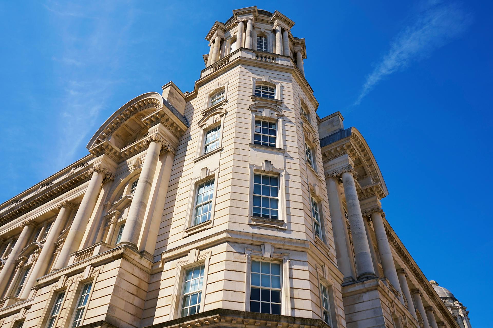 Low angle view of the iconic Port of Liverpool Building with blue sky