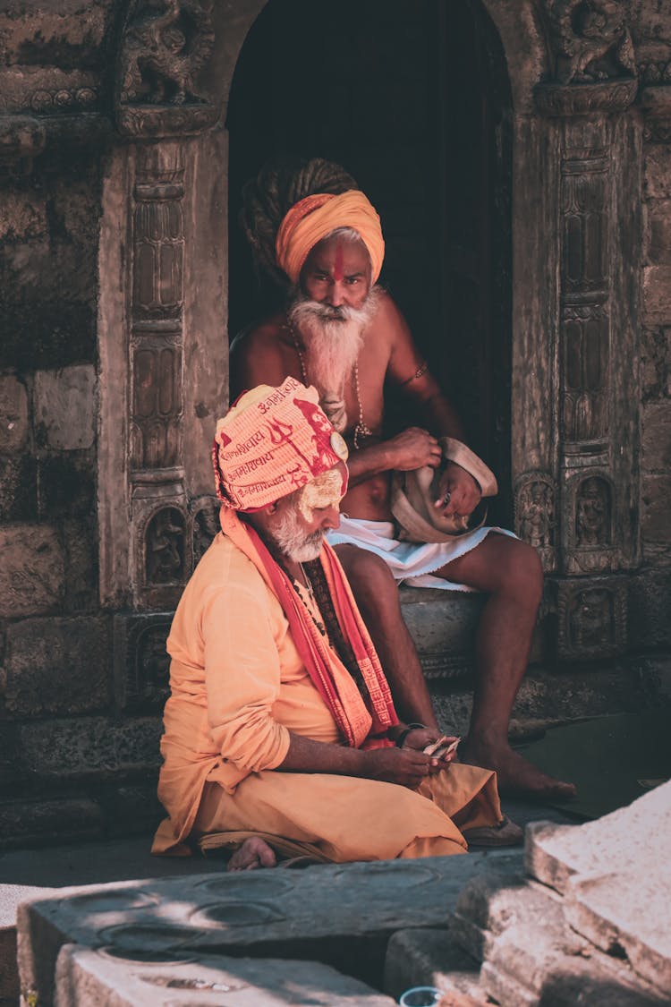 Elderly Bearded Men In Turbans Sitting In Front Of A Temple 