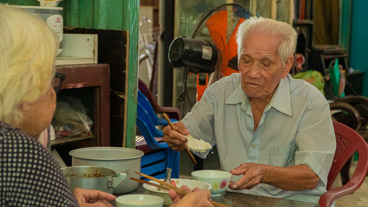 Senior Malaysian couple at home where a continuous oxygen supply is set up