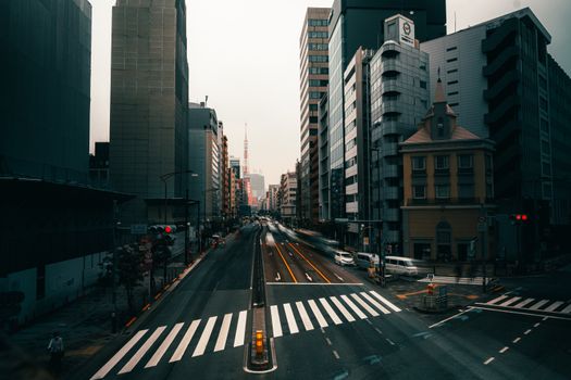High angle view of a bustling Tokyo street with the iconic Tokyo Tower in the distance.