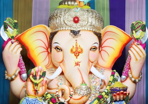 Free Colorful close-up of a Lord Ganesha sculpture adorned with traditional ornaments. Stock Photo