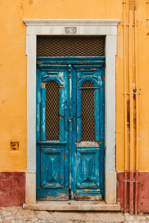 Blue Wooden Door on Concrete Building