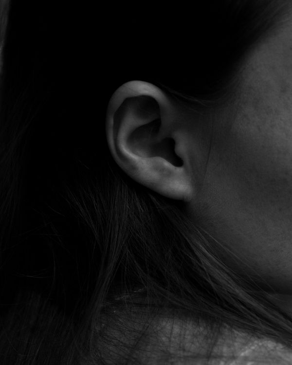 Close-up of Woman Ear on Black Background · Free Stock Photo