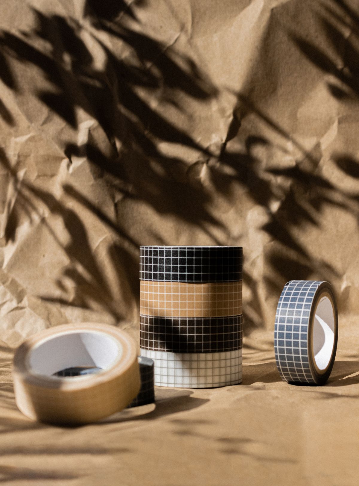 Grid patterned tapes on a brown background, perfect for a checkerboard game mat