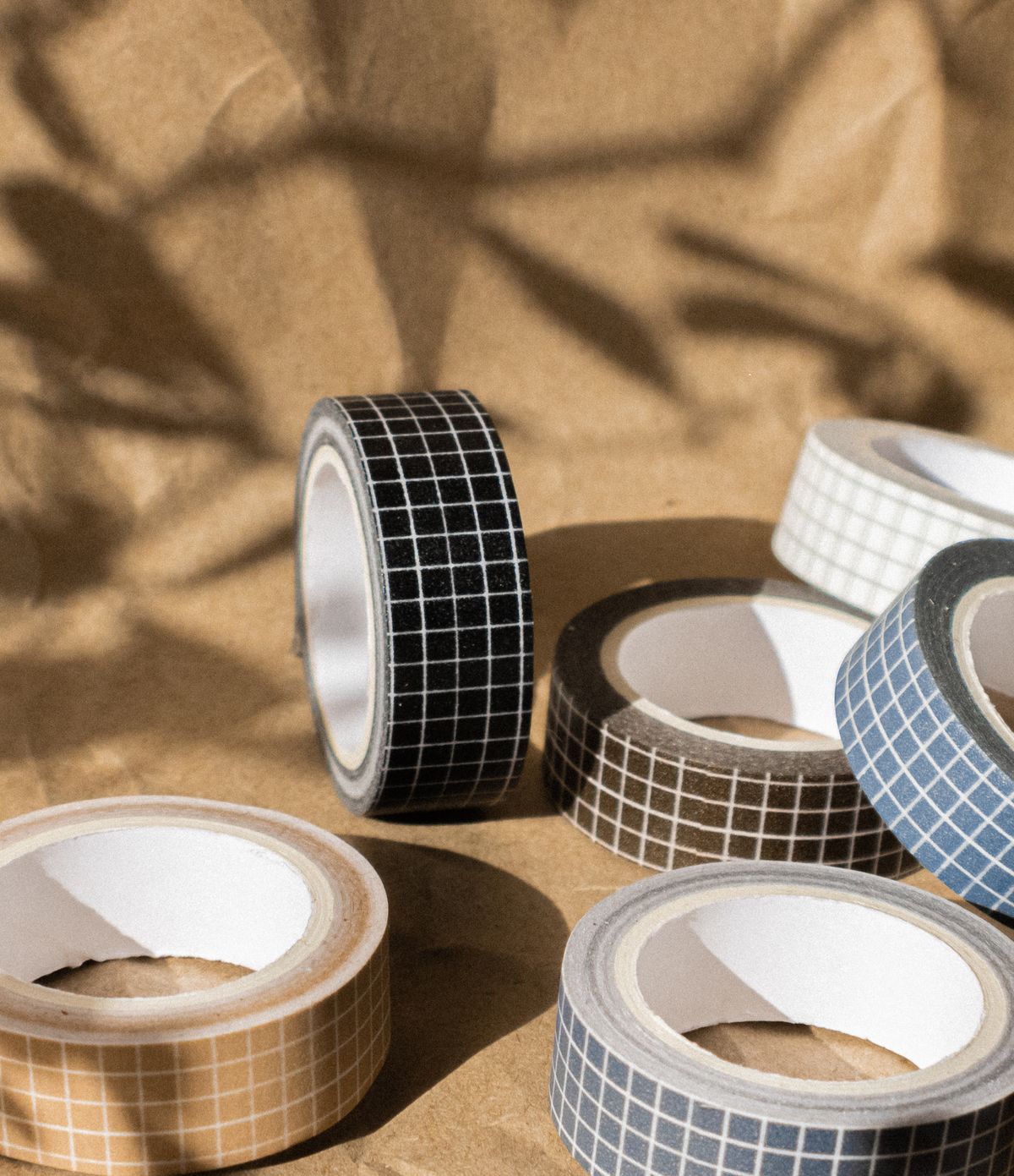 Decorative tape rolls with grid patterns on craft paper for woven placemats