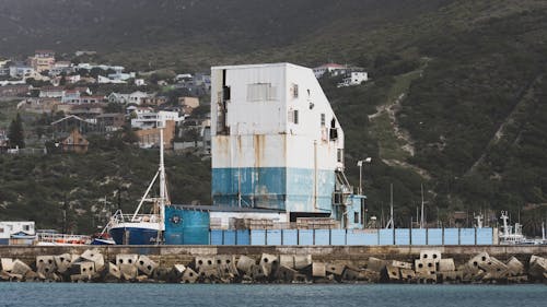 Building in Harbor in Mountains Landscape