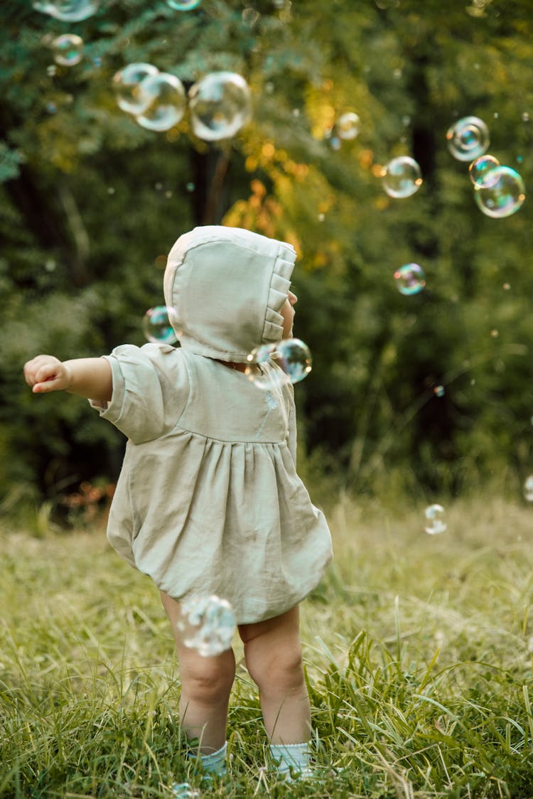 Toddler Standing On Green Grass