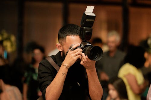 Man in Black T-shirt Holding Black Dslr Camera