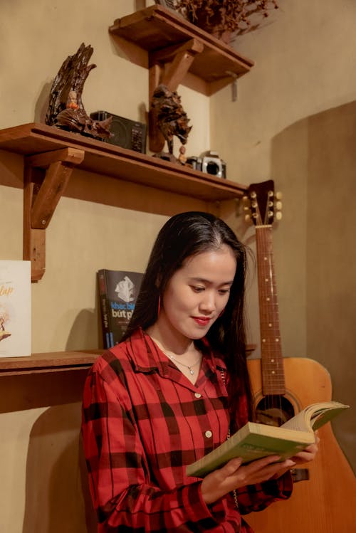 Cute asian girl with long hair reading book