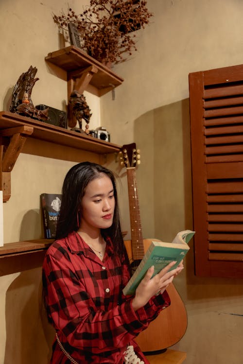 Cute asian girl with long hair reading book