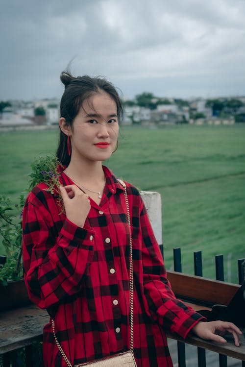 Cute asian girl with long hair on the windy balcony