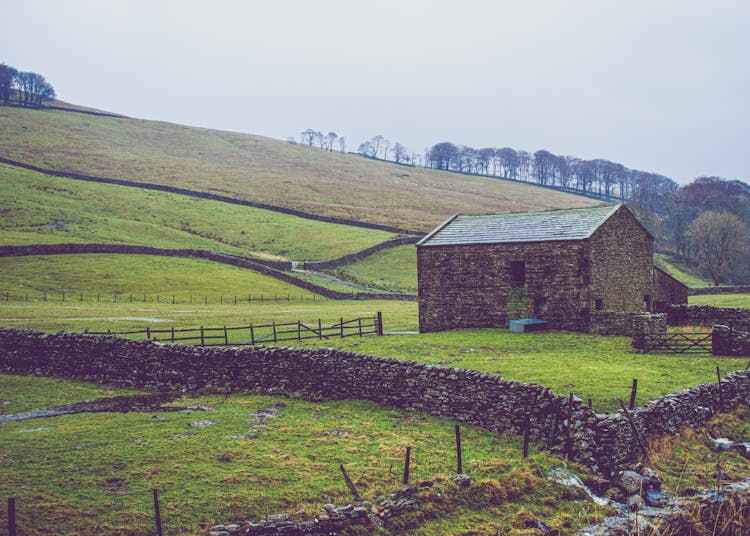 Barn In Valley In Mountains Landscape