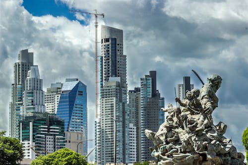 Modern Buildings in City with Classical Sculpture in front of them