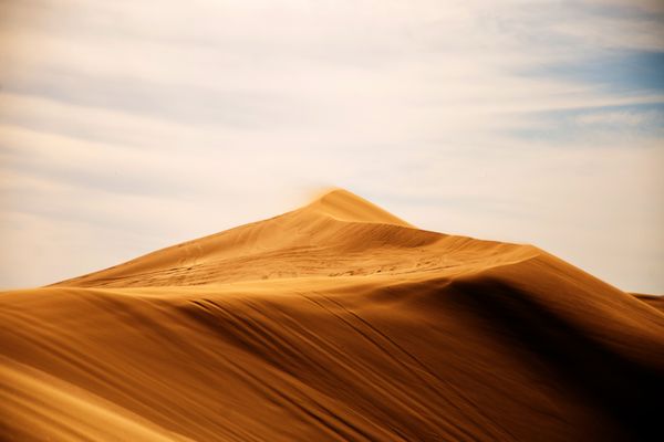 Sand dunes stretching to the horizon — photo by Emiliano Arano on Pexels