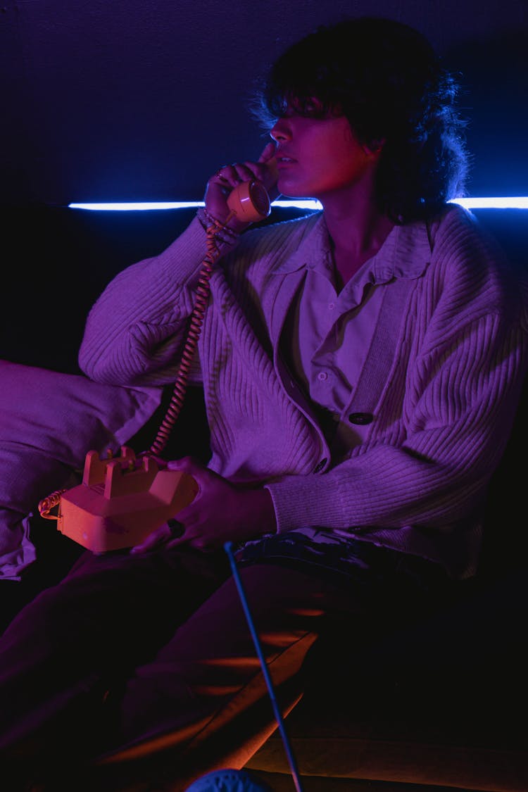 Woman Talking On Phone In Dark Room