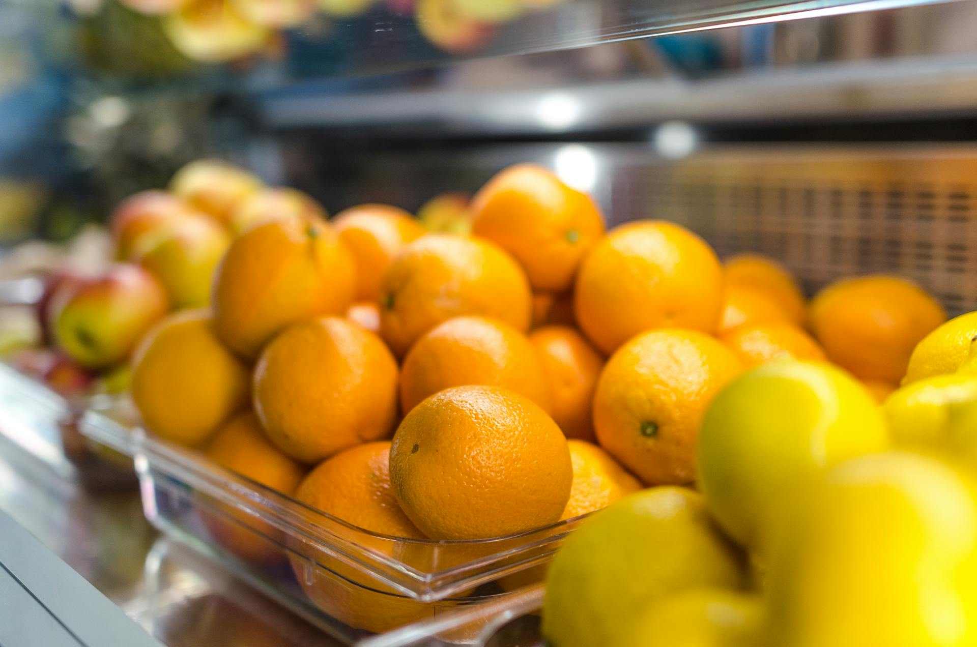 A vibrant display of fresh oranges and lemons in a market setting, emphasizing health and freshness.